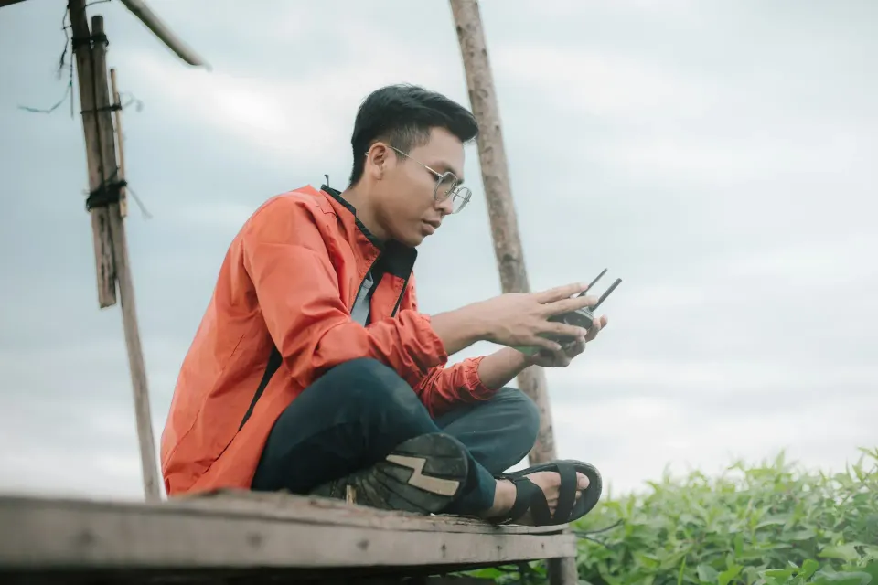 Pengguna memakai ponsel di lapangan